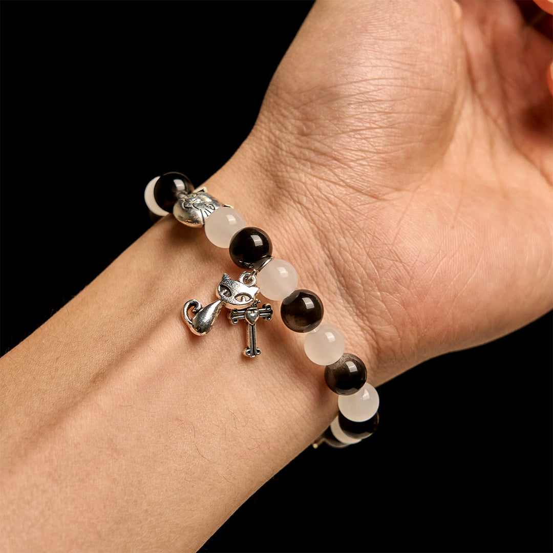 Christianartworkshop Bracelet animalier avec perles représentant une vache et un chat noirs et blancs, symbole de la bénédiction de Notre-Dame - image 1