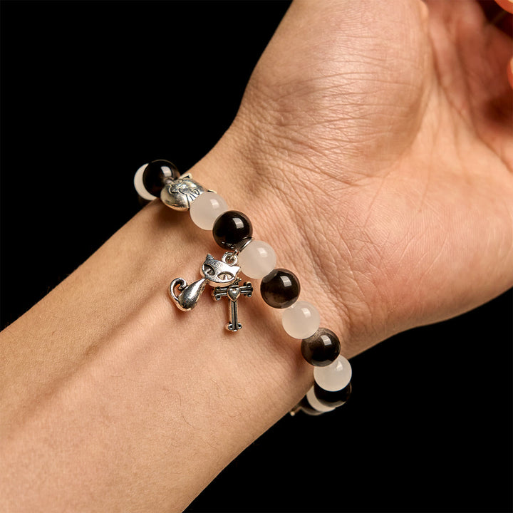 Christianartworkshop Bracelet animalier avec perles représentant une vache et un chat noirs et blancs, symbole de la bénédiction de Notre-Dame - image 1