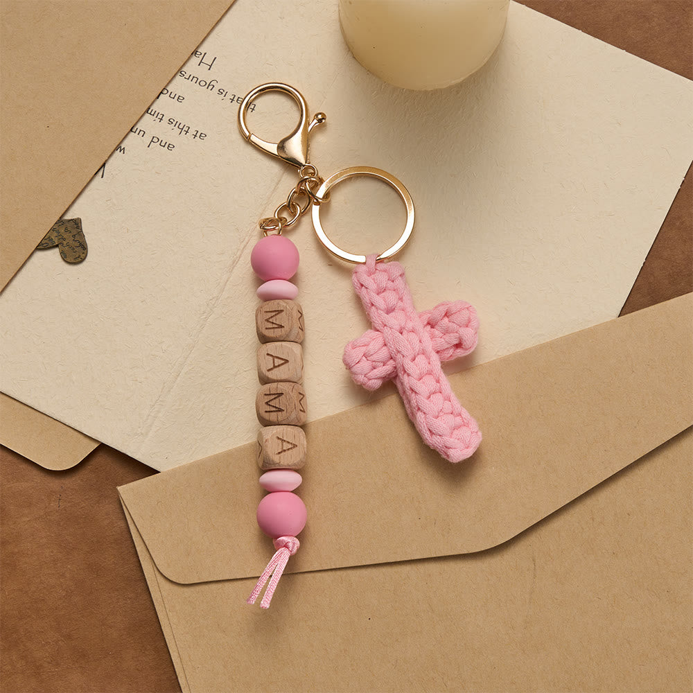 Christianartworkshop Porte-clés croix en crochet doux avec perles gravées « MAMA » : incarne la grâce, la fidélité et la chaleur. - Rose - image 0