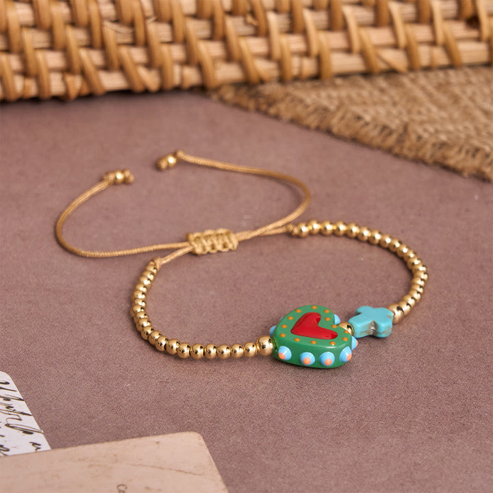 Christianartworkshop Bracelet ajustable en perles dorées, orné d'un cœur sacré décoré à la main, d'une petite croix et d'un motif de dessin animé. - image 13