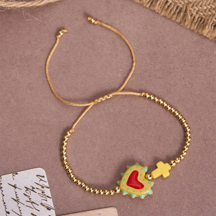 Christianartworkshop Bracelet ajustable en perles dorées, orné d'un cœur sacré décoré à la main, d'une petite croix et d'un motif de dessin animé. - B - image 4