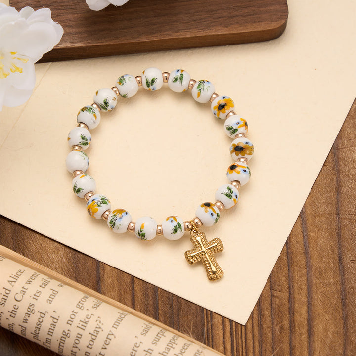 Christianartworkshop Bracelet extensible en perles de céramique à motif floral (4 styles) avec breloque croix dorée : symbole de douce grâce céleste - Jaune - image 4