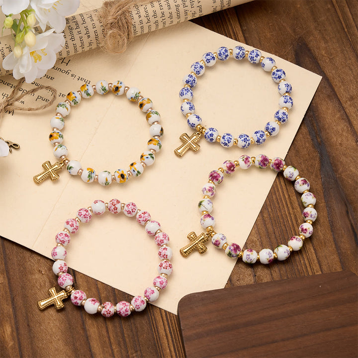 Christianartworkshop Bracelet extensible en perles de céramique à motif floral (4 styles) avec breloque croix dorée : symbole de douce grâce céleste - image 1