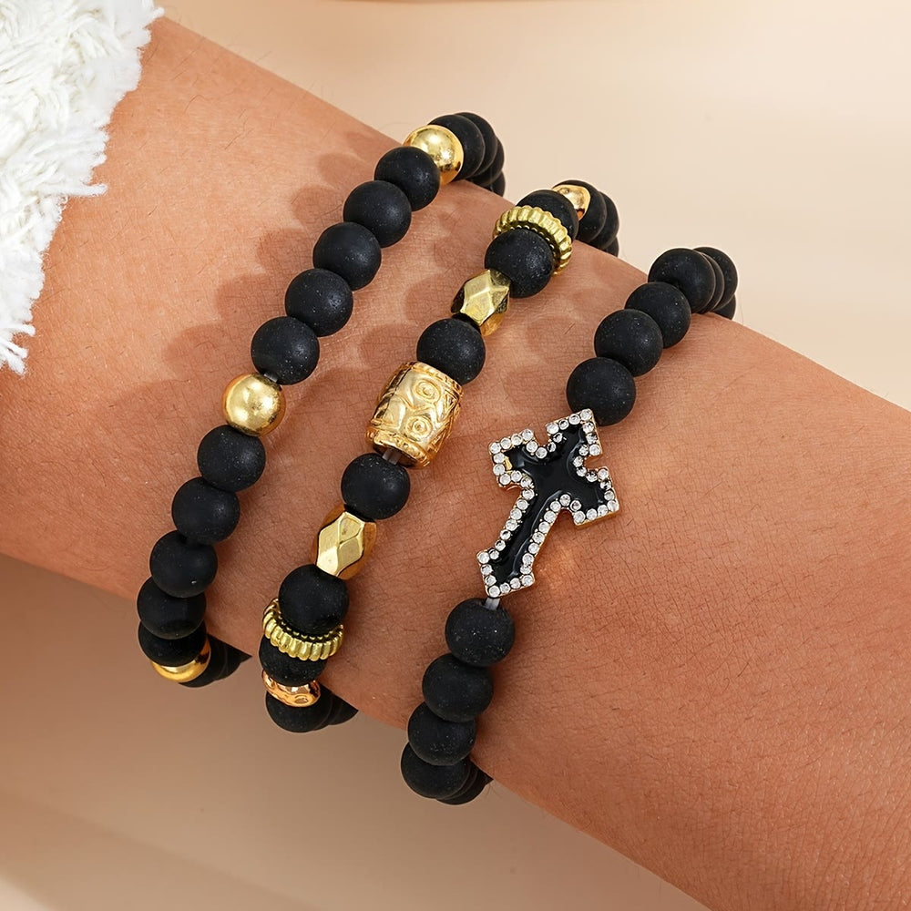 Christianartworkshop Bracelet extensible multicouche en perles de pierre noire mate avec croix pavée de zircon et entretoises dorées sculptées - image 1